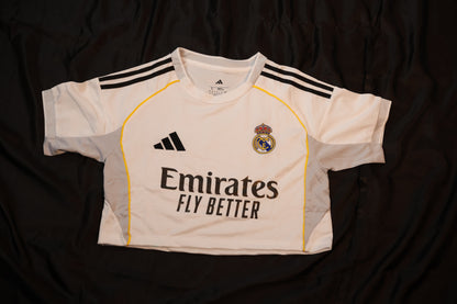 White sports jersey with black stripes and branding on a dark background
